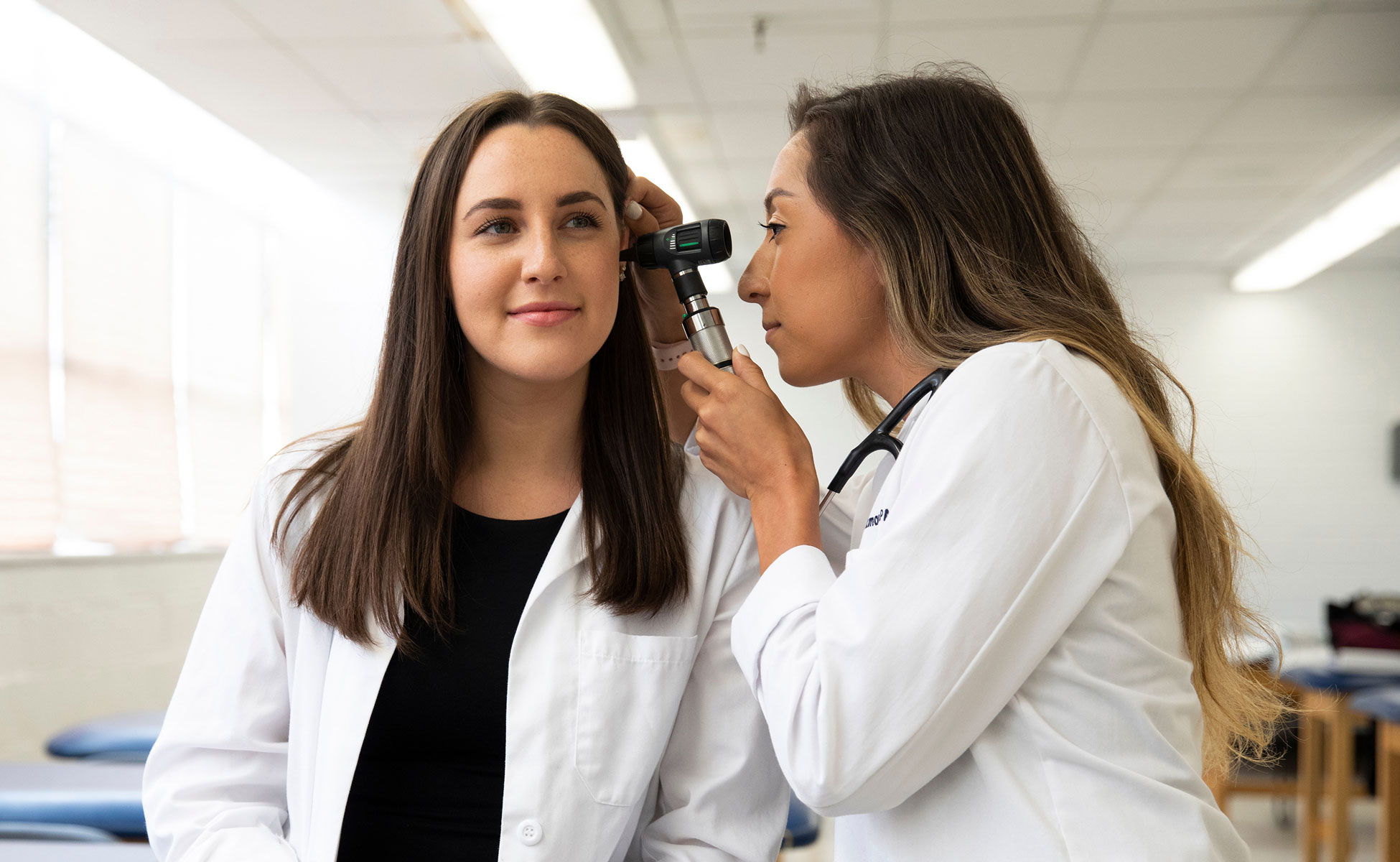 PA student practicing using otoscope
