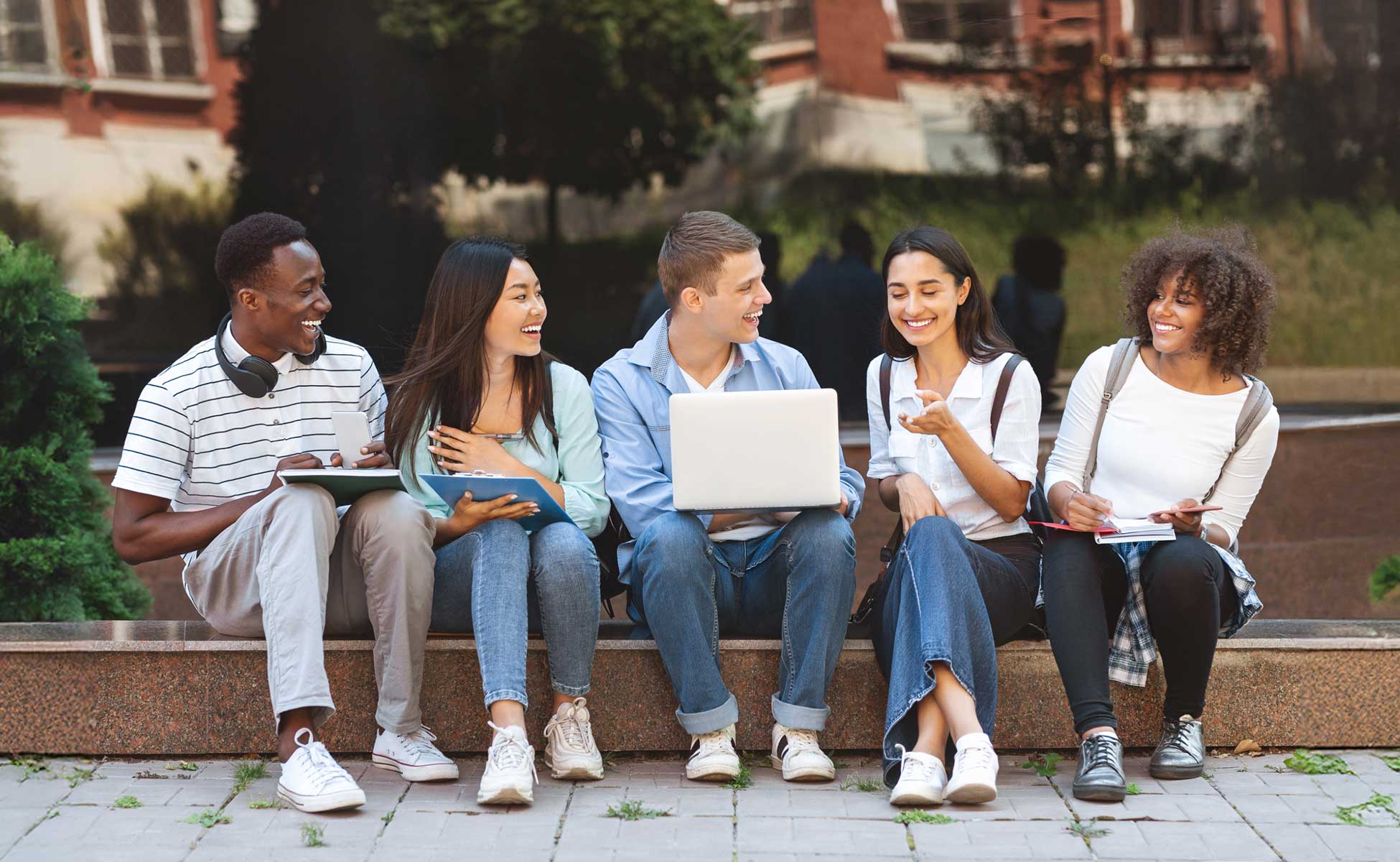 Occupational therapy smiling while holding OT tools.