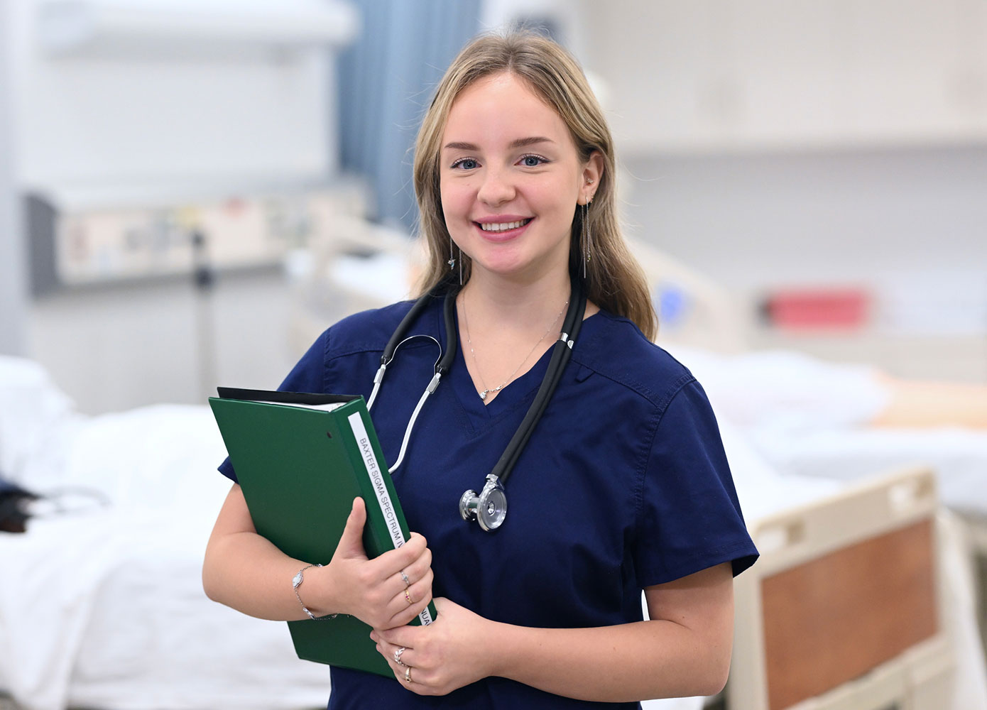 Female FNP student smiling in medical setting