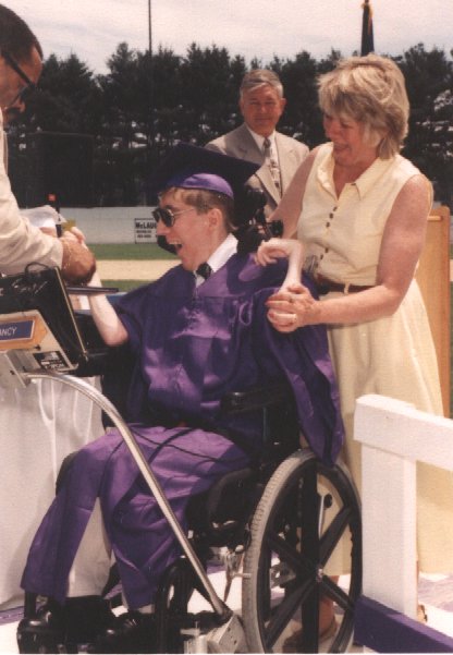 man using wheelchair at graduation