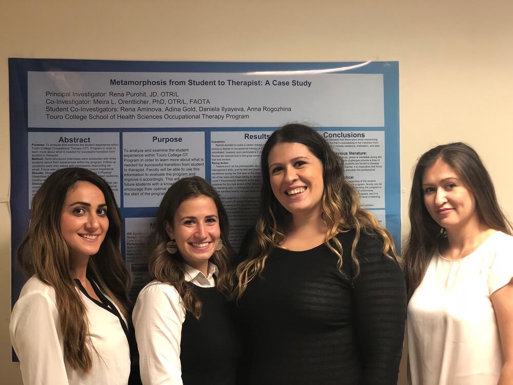 four women before a poster board