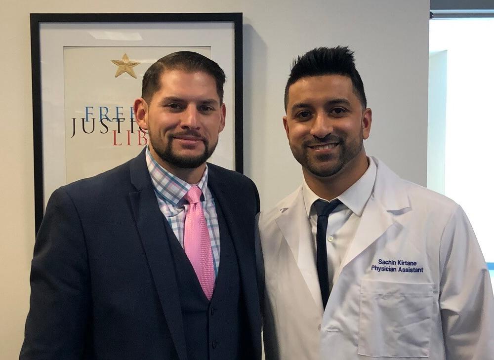 Thirty members of the class of 2019 Touro’s School of Health Sciences Physician Assistant Winthrop Extension Center (WEC)  donned their white coat in a ceremony on January 11. Above, PA Sachin Kirtane stands next to Matthew Tommasino, PA-C MS, associate program director of the PA-Winthrop program.