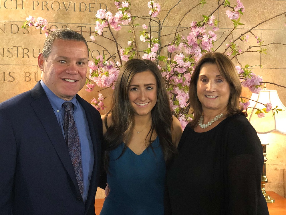 As one of the 42 graduates of Touro's School of Health Sciences-Manhattan Physician Assistant program, Alexa DellaTorre (center, flanked by her parents) donned her white coat in a ceremony on May 9. Next year, she will be working in the oncology ward of New York Presbyterian Weill Cornell Medical Center.