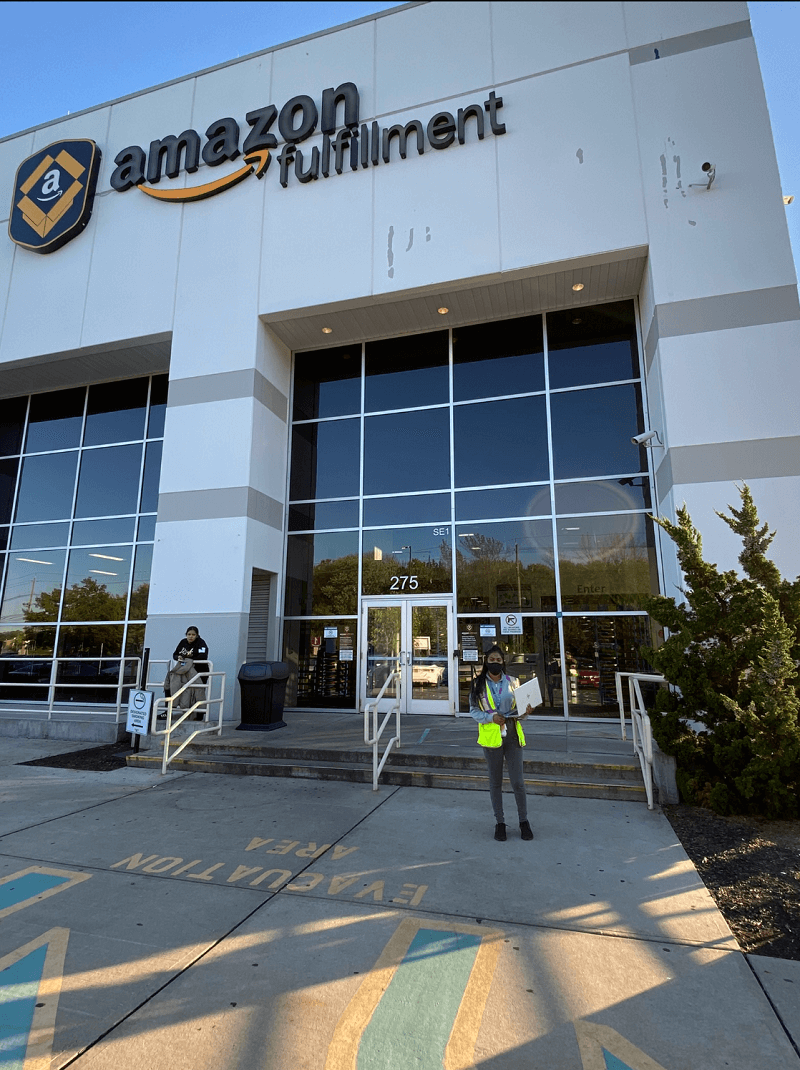 Raveena Mohabir stands by the Amazon fulfillment center where she works. 