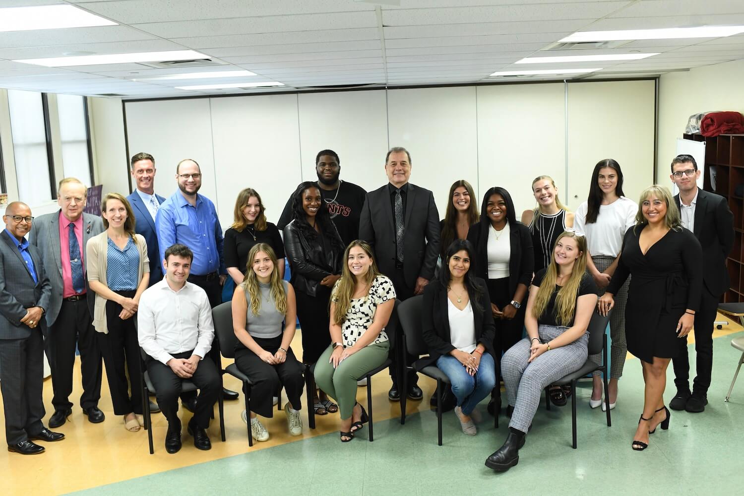 Students and faculty members pose for a photograph together