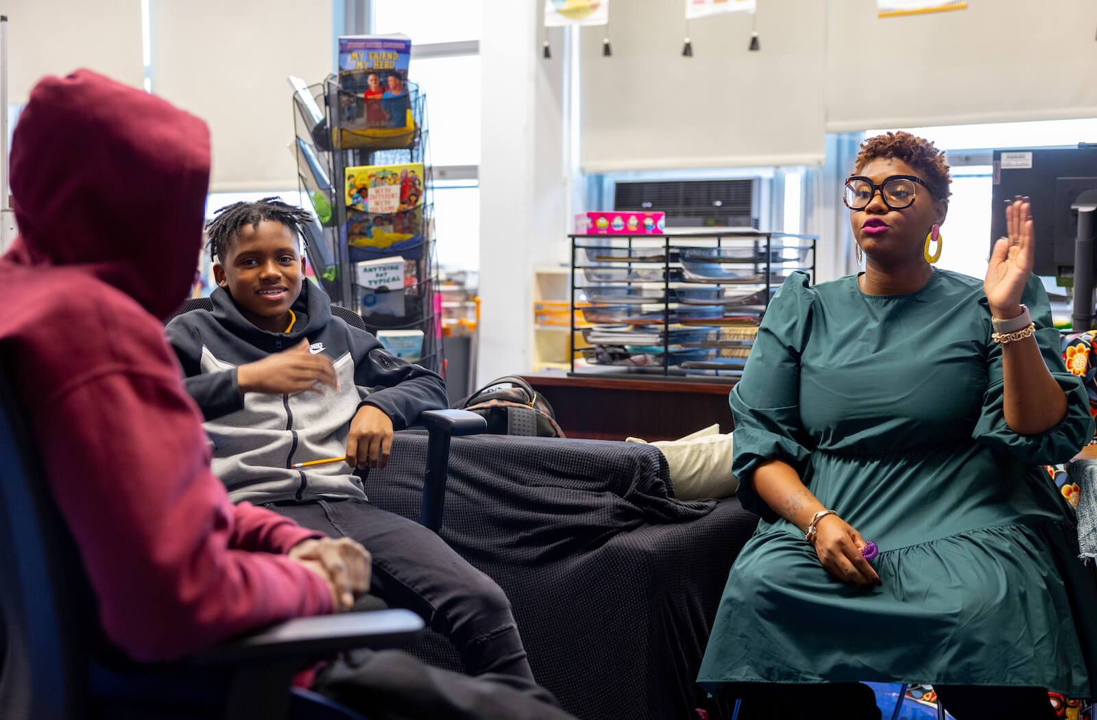 SHS alumna Shatima Howard sits with her students