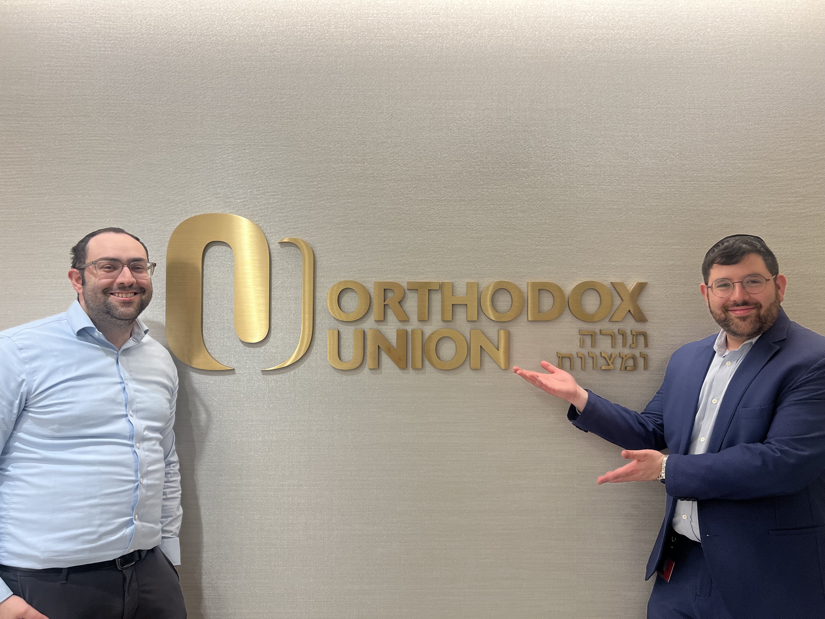 Shai Kopitnikoff and Tzuri Merzel, I-O Psychology alums stand in front of the Orthodox Union.