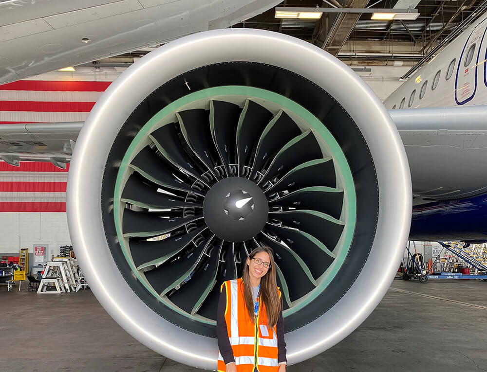 Lorraine DeCastro standing in front of an airplane