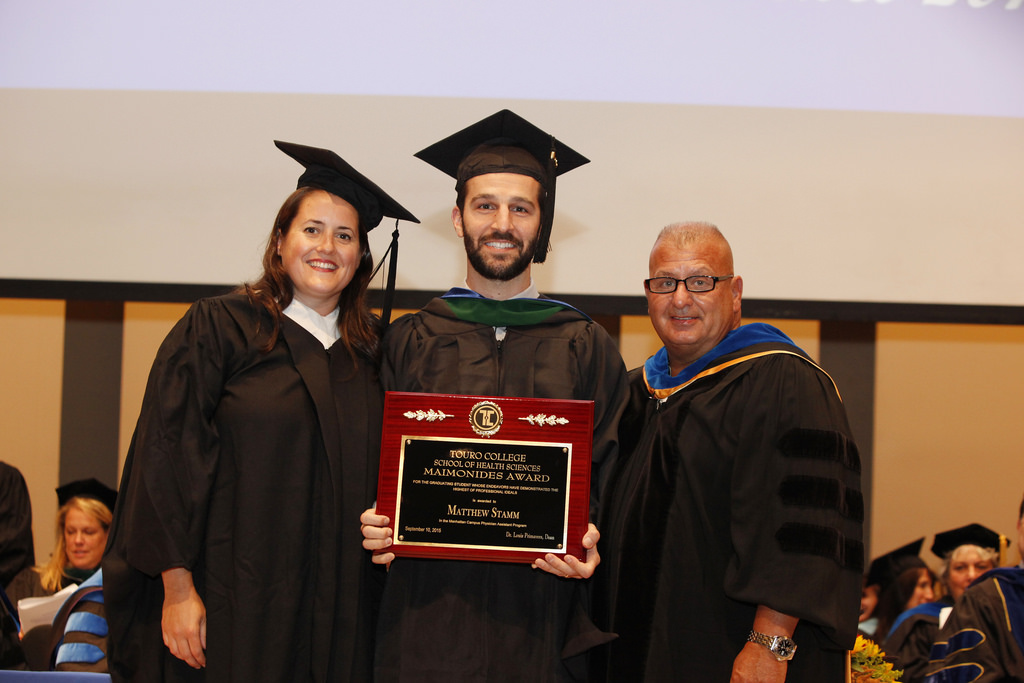 Kristen Thomson, Director of the Manhattan PA Program, and Dr. Joseph Tommasino, Chair of the Dept. of PA Program, present Maimonides Award to Matthew Stamm  at School of Health Sciences commencement ceremony 